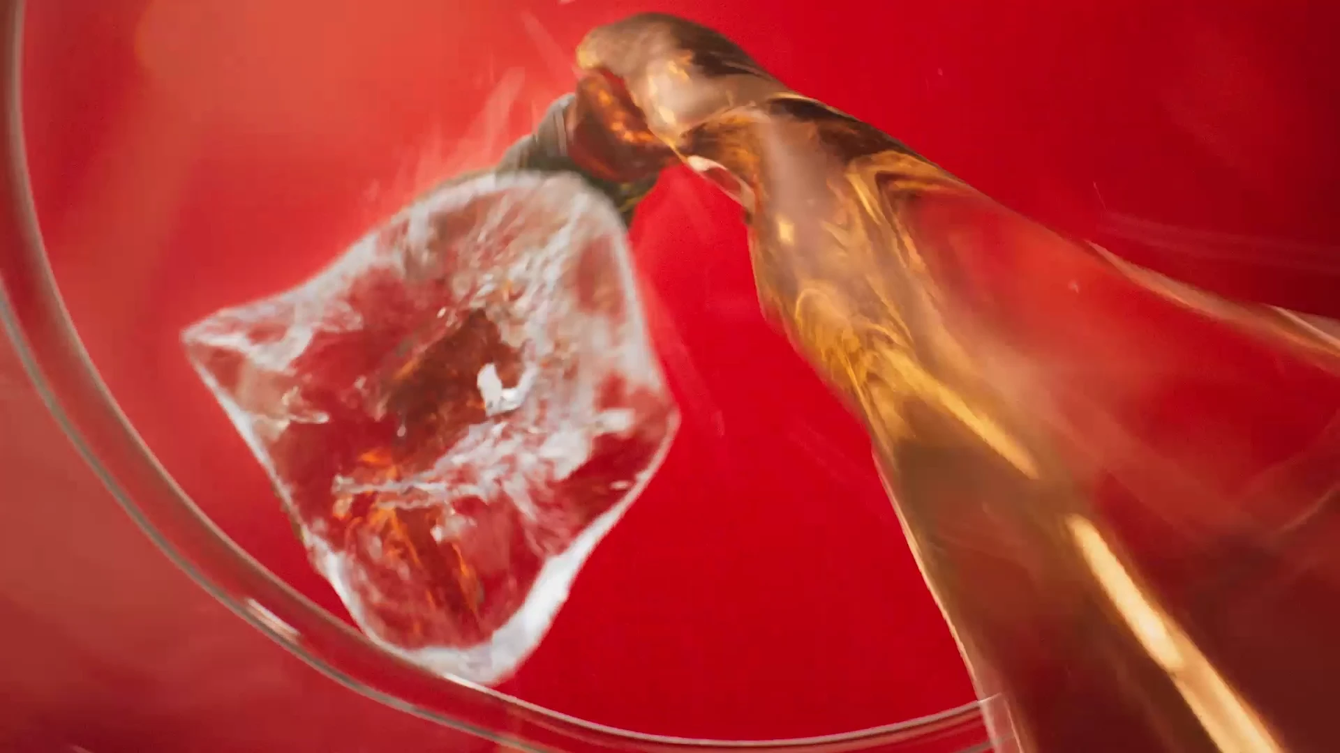 Ice and golden liquid in a dynamic finished Rivella product shot